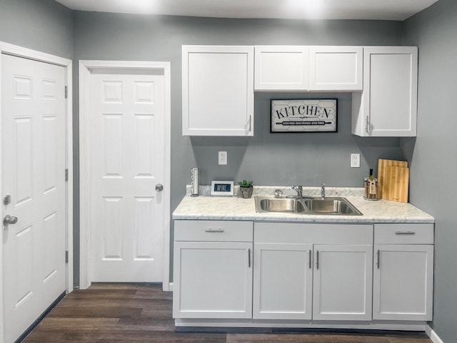 kitchen featuring white cabinets, dark hardwood / wood-style floors, and sink