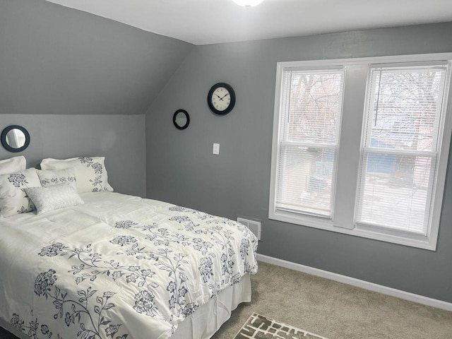 carpeted bedroom with lofted ceiling