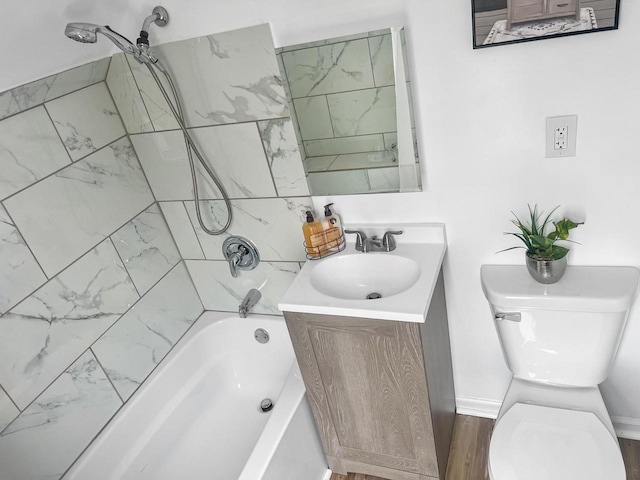 full bathroom featuring vanity, hardwood / wood-style flooring, toilet, and tiled shower / bath combo