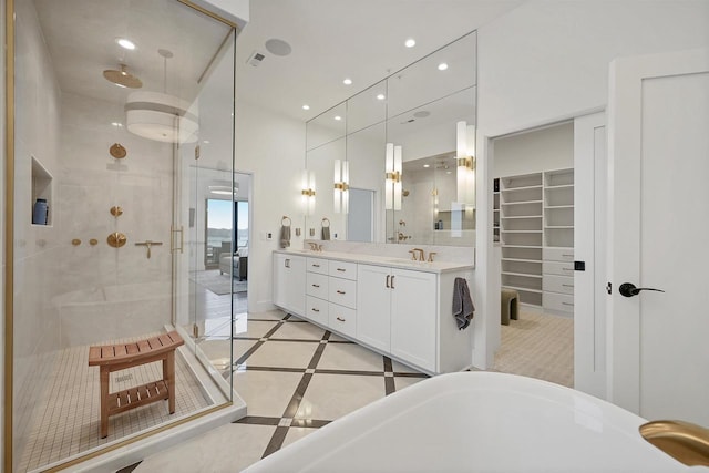 bathroom with plus walk in shower, vanity, and tile patterned flooring