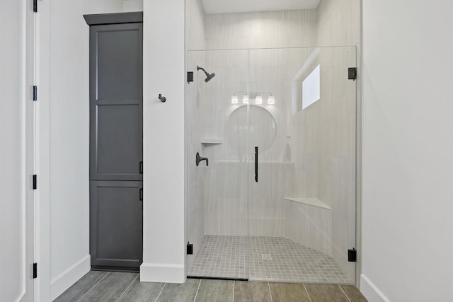 bathroom with a shower with door