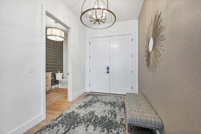 entryway featuring a notable chandelier and hardwood / wood-style flooring