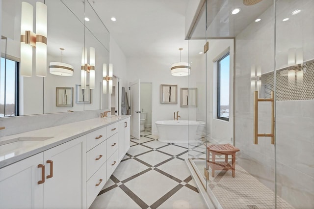 full bathroom featuring vanity, toilet, and independent shower and bath