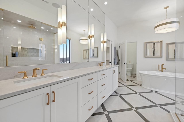 full bathroom featuring vanity, separate shower and tub, and toilet