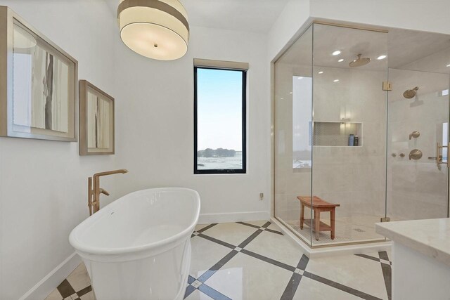 bathroom with tile patterned flooring and separate shower and tub