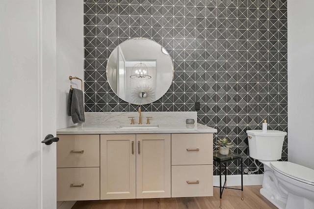 bathroom featuring hardwood / wood-style floors, vanity, and toilet