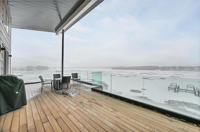 wooden deck featuring a water view and area for grilling