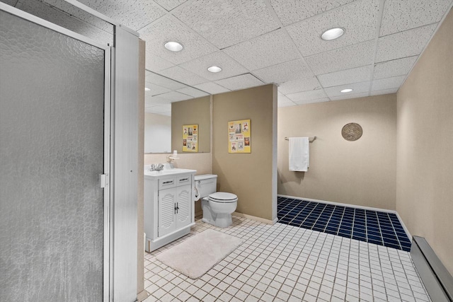 bathroom with a paneled ceiling, a shower with door, vanity, and tile patterned flooring