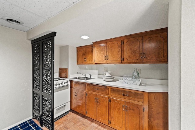 kitchen featuring a paneled ceiling, sink, white electric stove, and light parquet floors