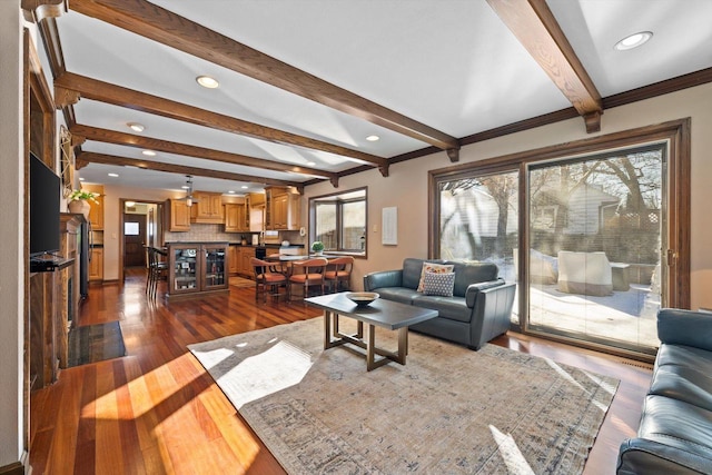 living room featuring a wealth of natural light, wood-type flooring, and beamed ceiling