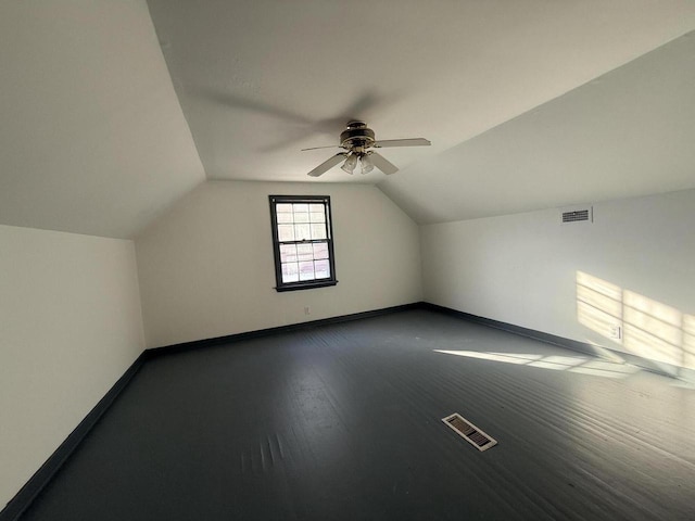 additional living space with ceiling fan, dark wood-type flooring, and lofted ceiling