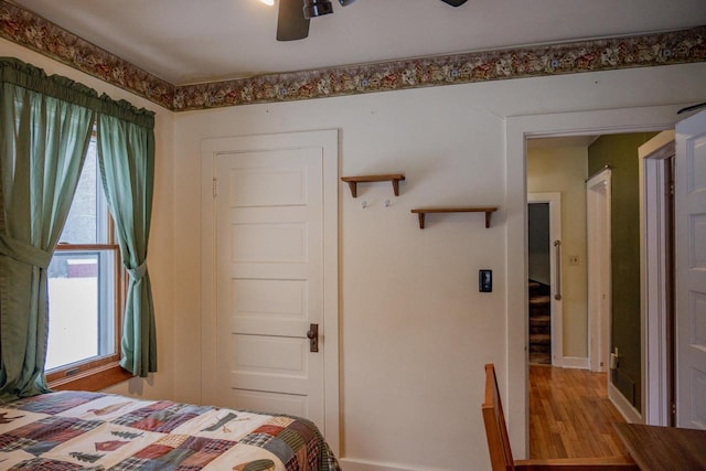 bedroom with hardwood / wood-style flooring and ceiling fan