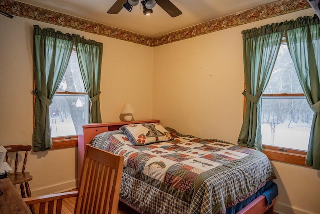 bedroom featuring multiple windows and ceiling fan