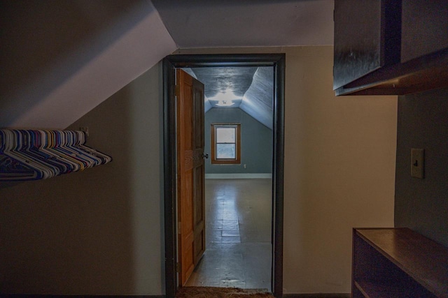 hall featuring vaulted ceiling