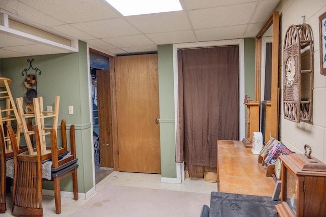 interior space with a paneled ceiling