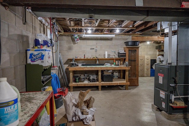 basement featuring heating unit and a workshop area