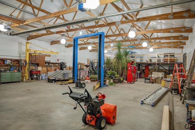 garage featuring a garage door opener and a workshop area