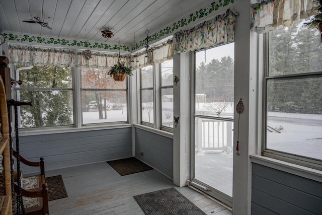 unfurnished sunroom with a wealth of natural light and wooden ceiling