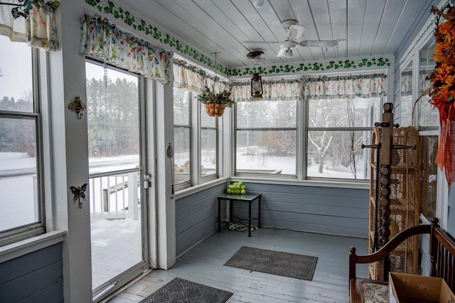 sunroom featuring wood ceiling and ceiling fan