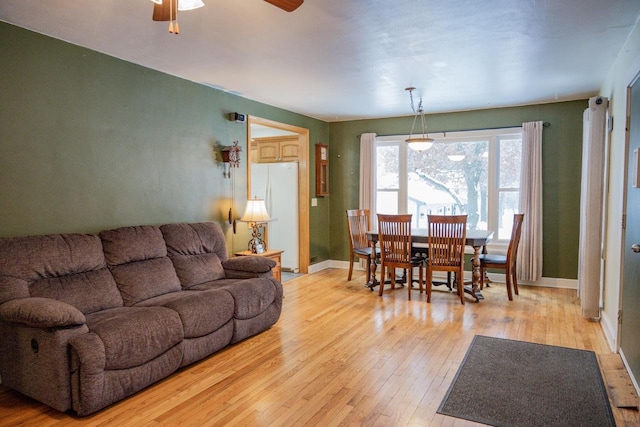 living room with ceiling fan and light hardwood / wood-style floors