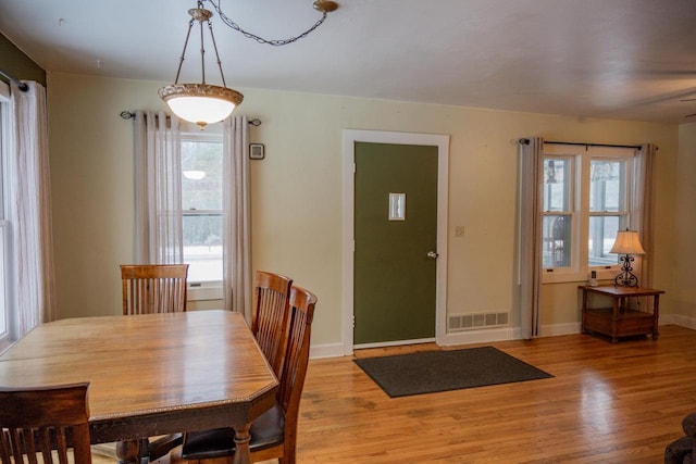 dining area with plenty of natural light and light hardwood / wood-style floors