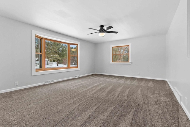 empty room featuring carpet flooring, ceiling fan, and a healthy amount of sunlight