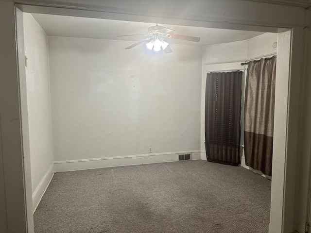 spare room featuring carpet floors and ceiling fan