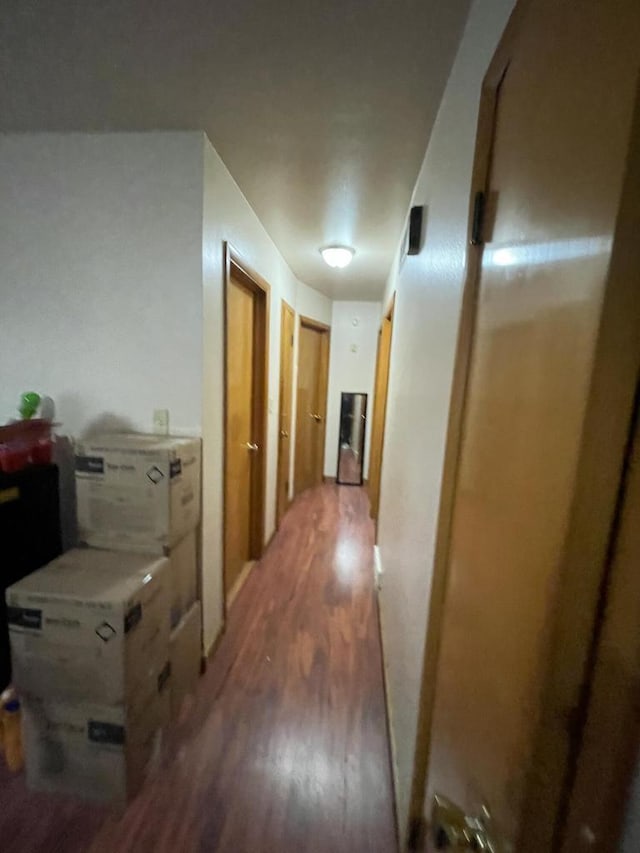 corridor with hardwood / wood-style floors