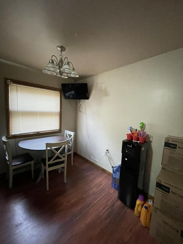 dining space with dark hardwood / wood-style flooring, washer / dryer, and an inviting chandelier