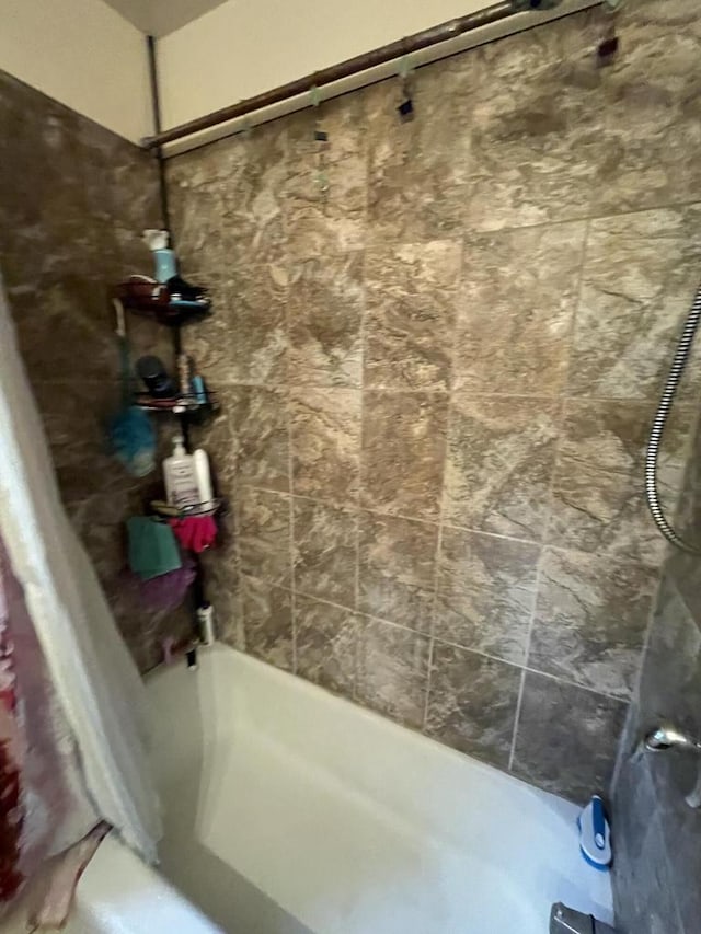 bathroom with shower / bathtub combination with curtain