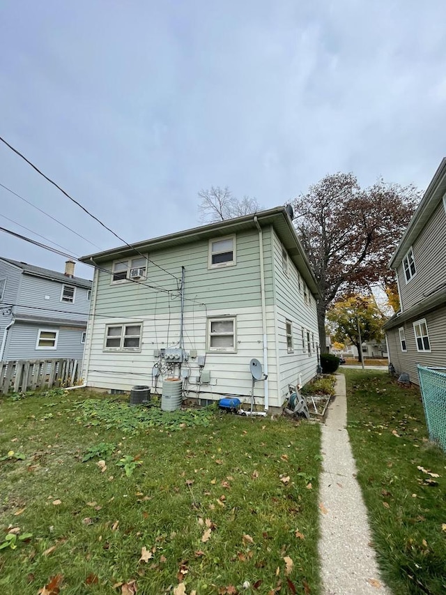 rear view of property with a yard