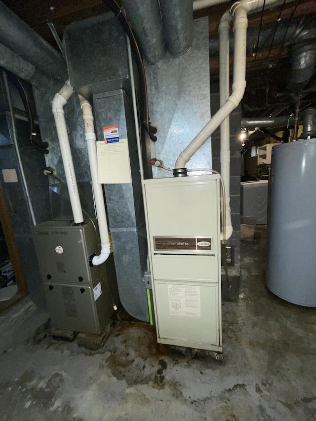 utility room featuring washer / clothes dryer and water heater