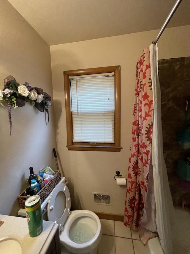 bathroom with tile patterned flooring, vanity, and toilet