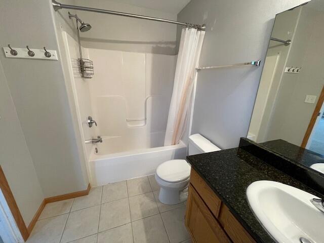 full bathroom featuring tile patterned flooring, vanity, toilet, and shower / bath combo with shower curtain