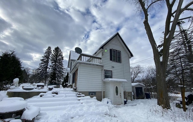 view of snowy exterior featuring a balcony