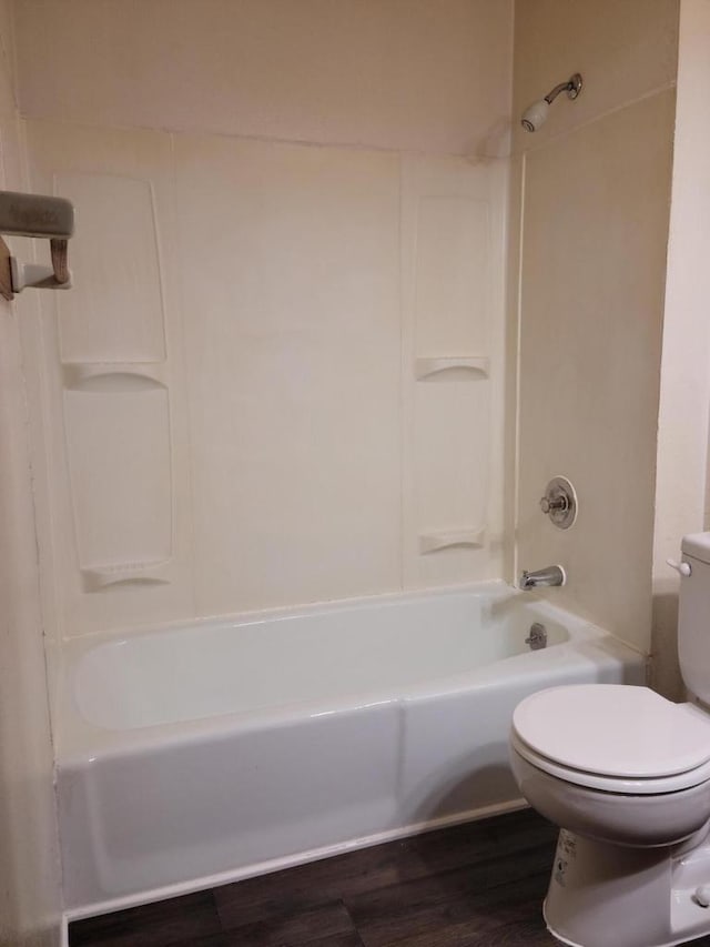 bathroom featuring hardwood / wood-style floors, shower / bathtub combination, and toilet