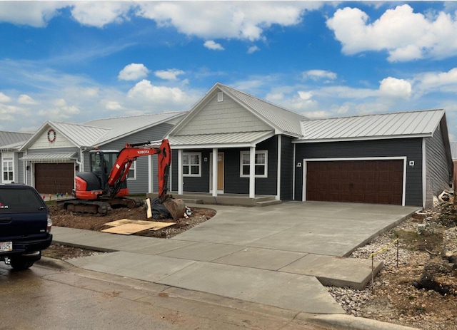 view of front of home with covered porch and a garage