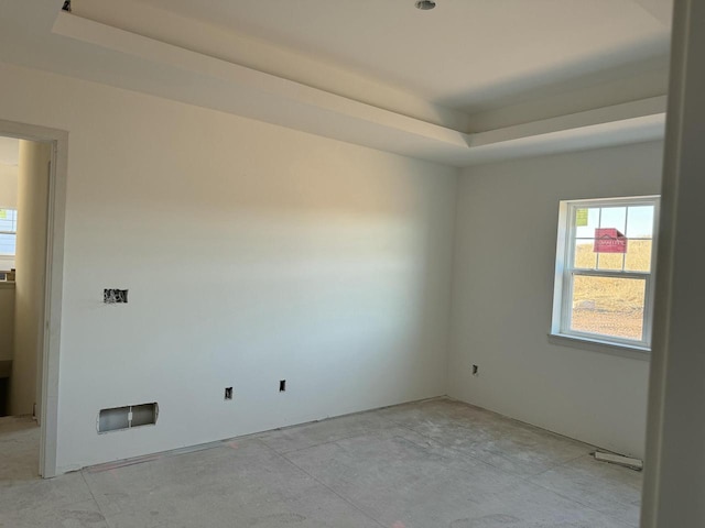 empty room featuring a tray ceiling