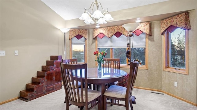 carpeted dining area with a notable chandelier and a healthy amount of sunlight