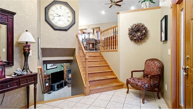 foyer with ceiling fan and light tile patterned flooring