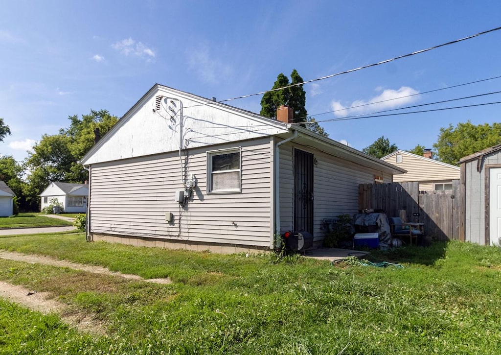 view of side of home with a lawn