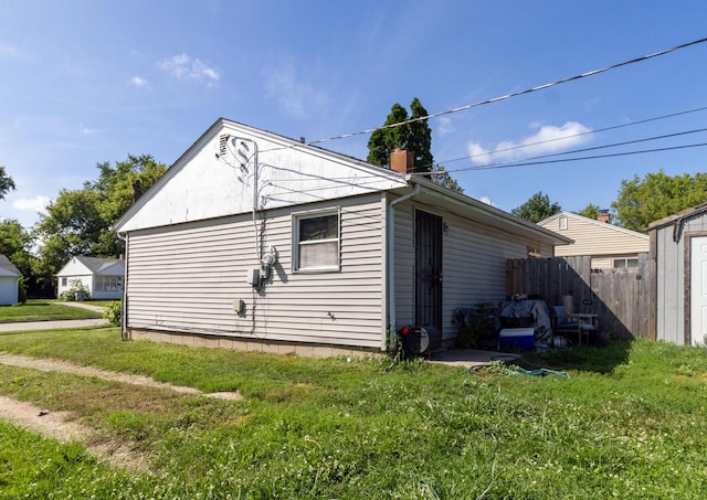 view of side of home with a lawn