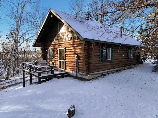 view of snowy exterior with a deck