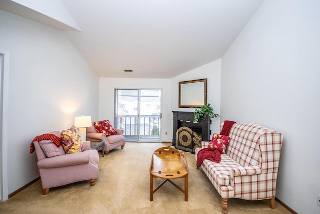 carpeted living room with lofted ceiling