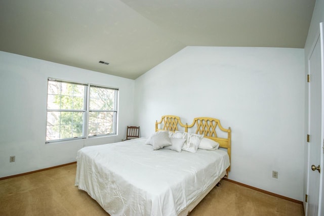 bedroom with light carpet and vaulted ceiling