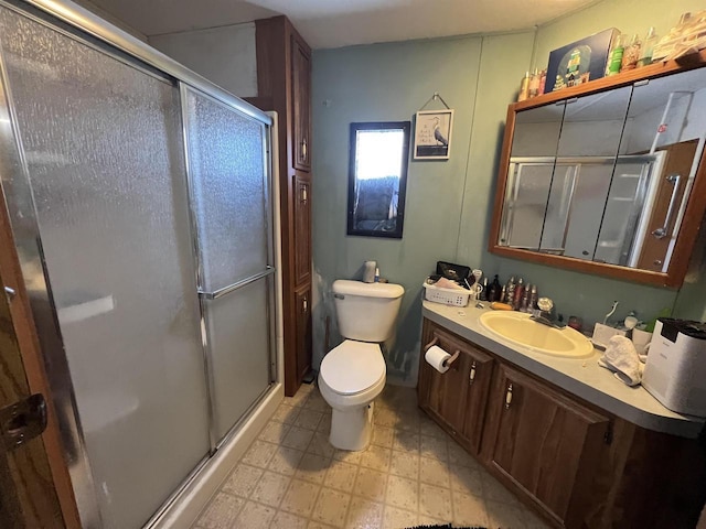 bathroom featuring toilet, vanity, and walk in shower