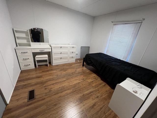 bedroom with dark wood-type flooring