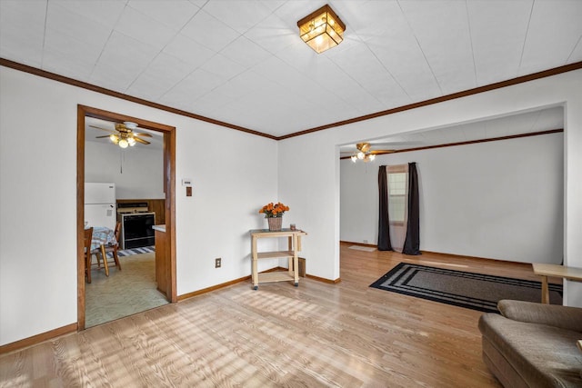 interior space featuring ceiling fan, hardwood / wood-style floors, and ornamental molding