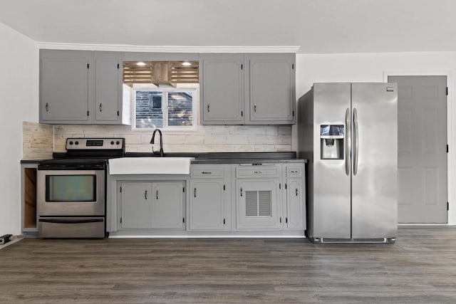 kitchen featuring appliances with stainless steel finishes, gray cabinets, tasteful backsplash, and sink