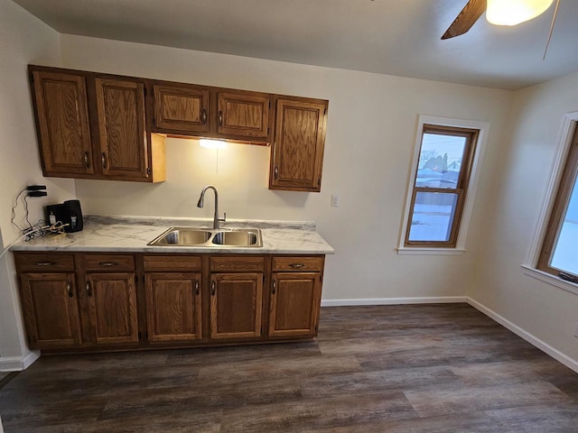 kitchen featuring dark hardwood / wood-style floors, ceiling fan, a healthy amount of sunlight, and sink